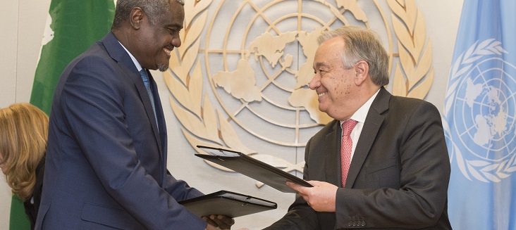 Secretary General António Guterres (right) and Moussa Faki Mahamat, Chairperson of the African Union Commission, shake hands after signing Joint UN-AU Framework for Enhancing Partnerships on Peace and Security.